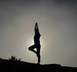 black and white photo of a woman doing yoga