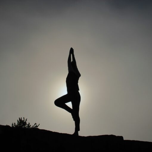 black and white photo of a woman doing yoga