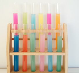 rainbow colored test tubes on a rack