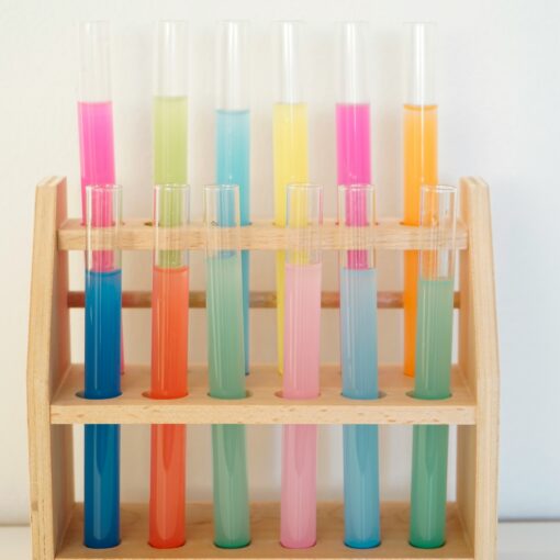 rainbow colored test tubes on a rack