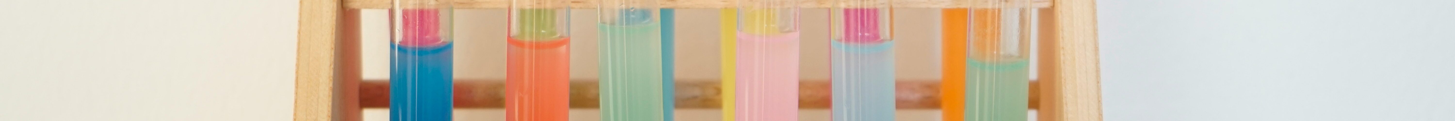 rainbow colored test tubes on a rack